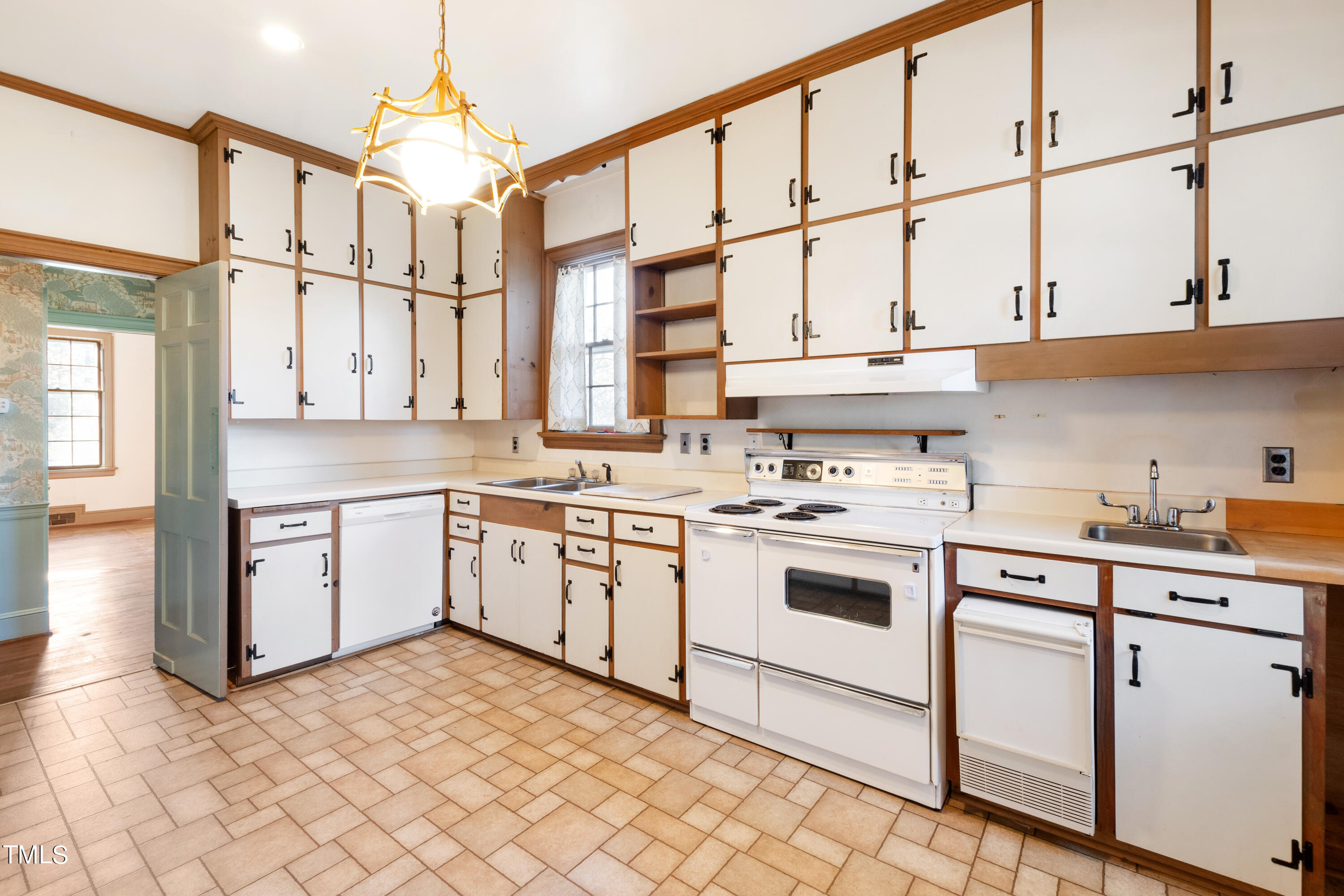 2522 Wake Drive Raleigh, NC 27608 - Photo 21 of 49 a kitchen with a stove a sink and white cabinets