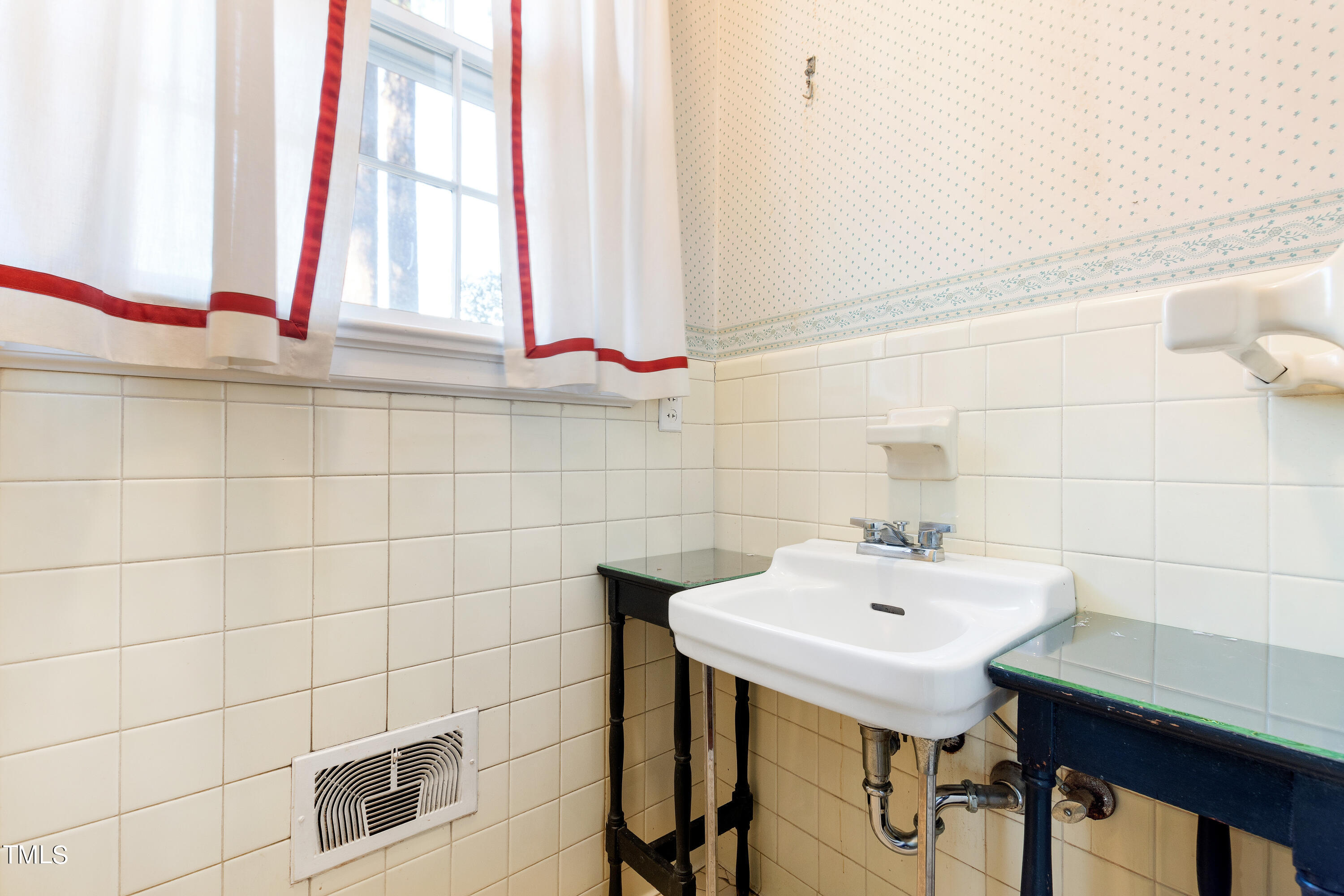 2522 Wake Drive Raleigh, NC 27608 - Photo 24 of 49 a bathroom with a sink and a mirror