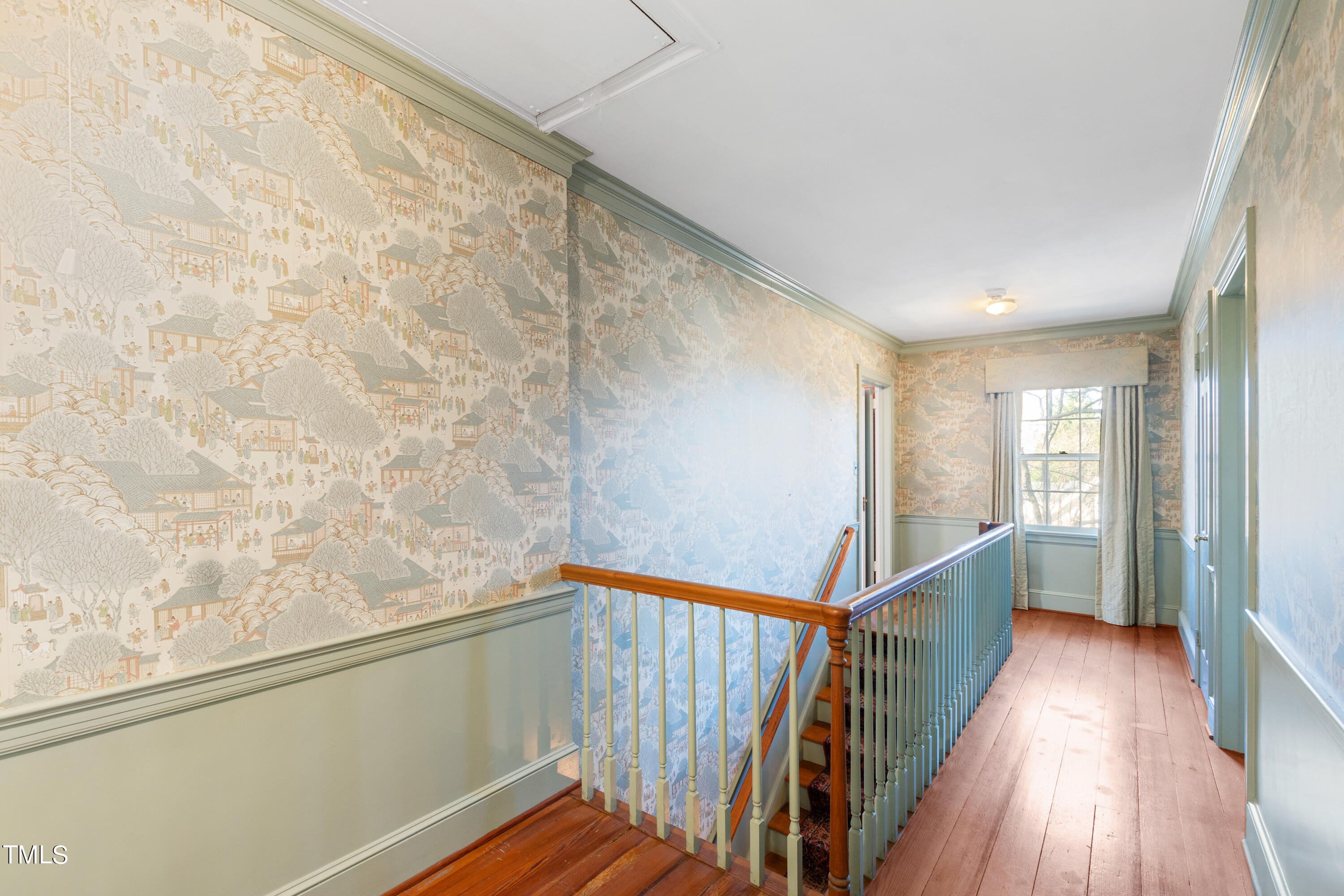 2522 Wake Drive Raleigh, NC 27608 - Photo 26 of 49 a view of a hallway with wooden floor and stairs