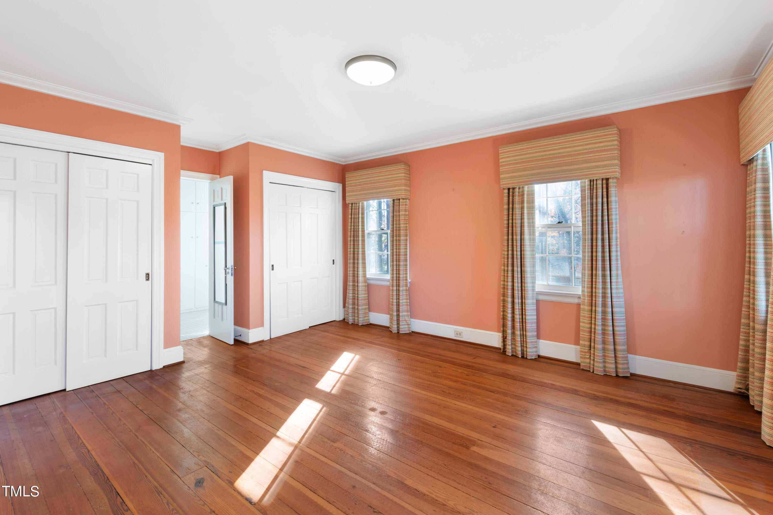 2522 Wake Drive Raleigh, NC 27608 - Photo 27 of 49 an empty room with wooden floor and windows