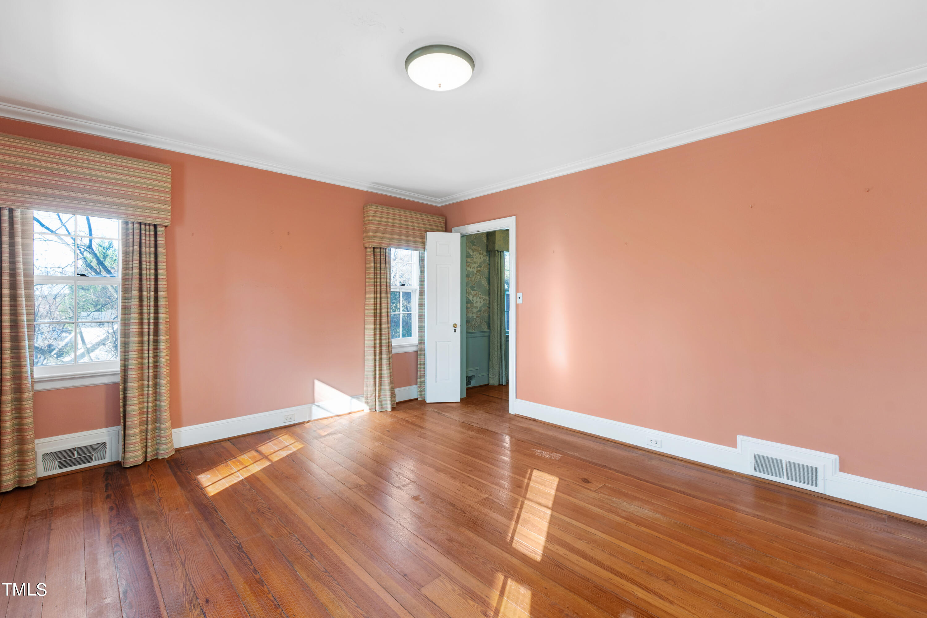 2522 Wake Drive Raleigh, NC 27608 - Photo 28 of 49 a view of an empty room with wooden floor and a window