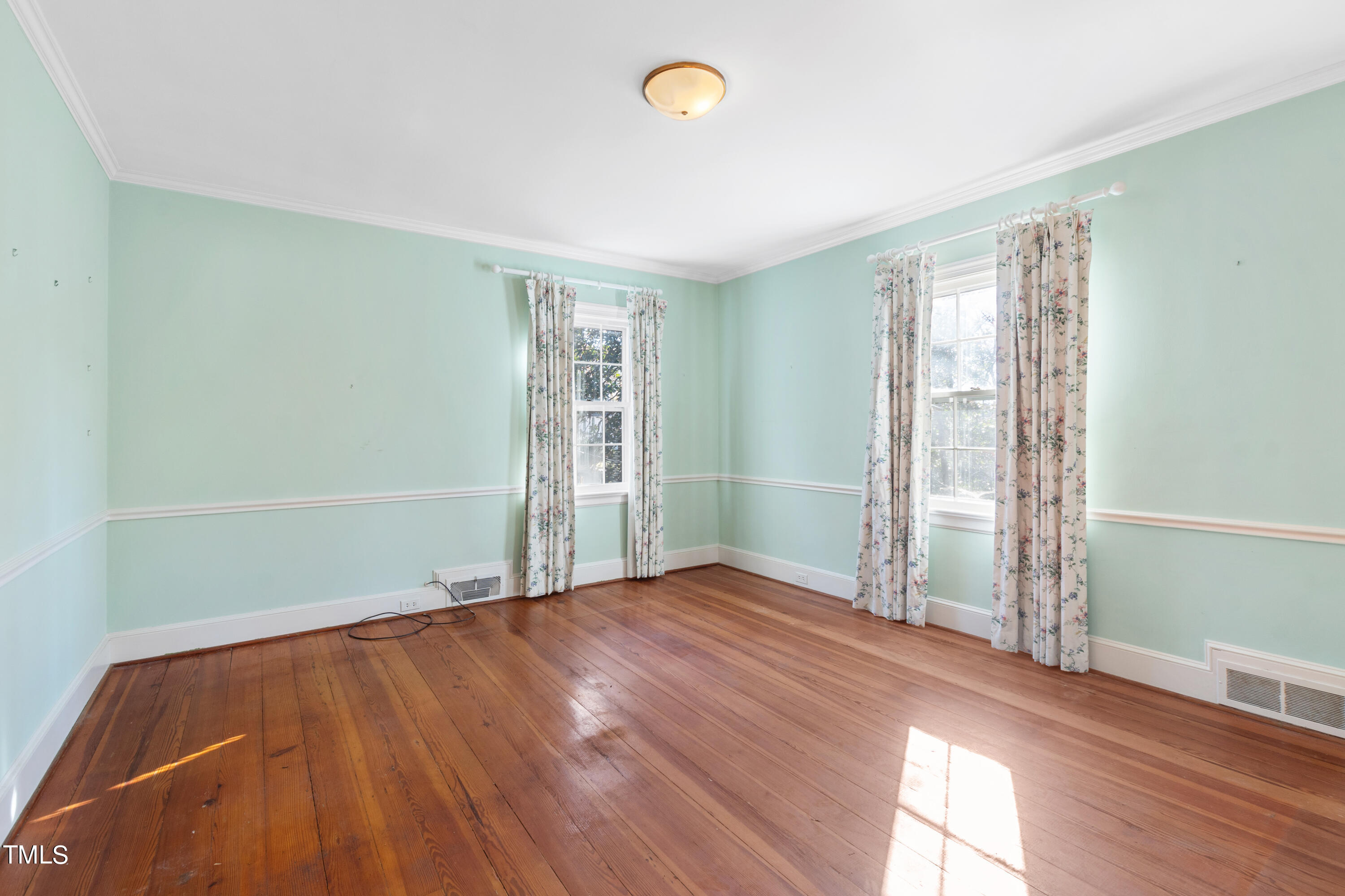 2522 Wake Drive Raleigh, NC 27608 - Photo 29 of 49 an empty room with wooden floor and windows