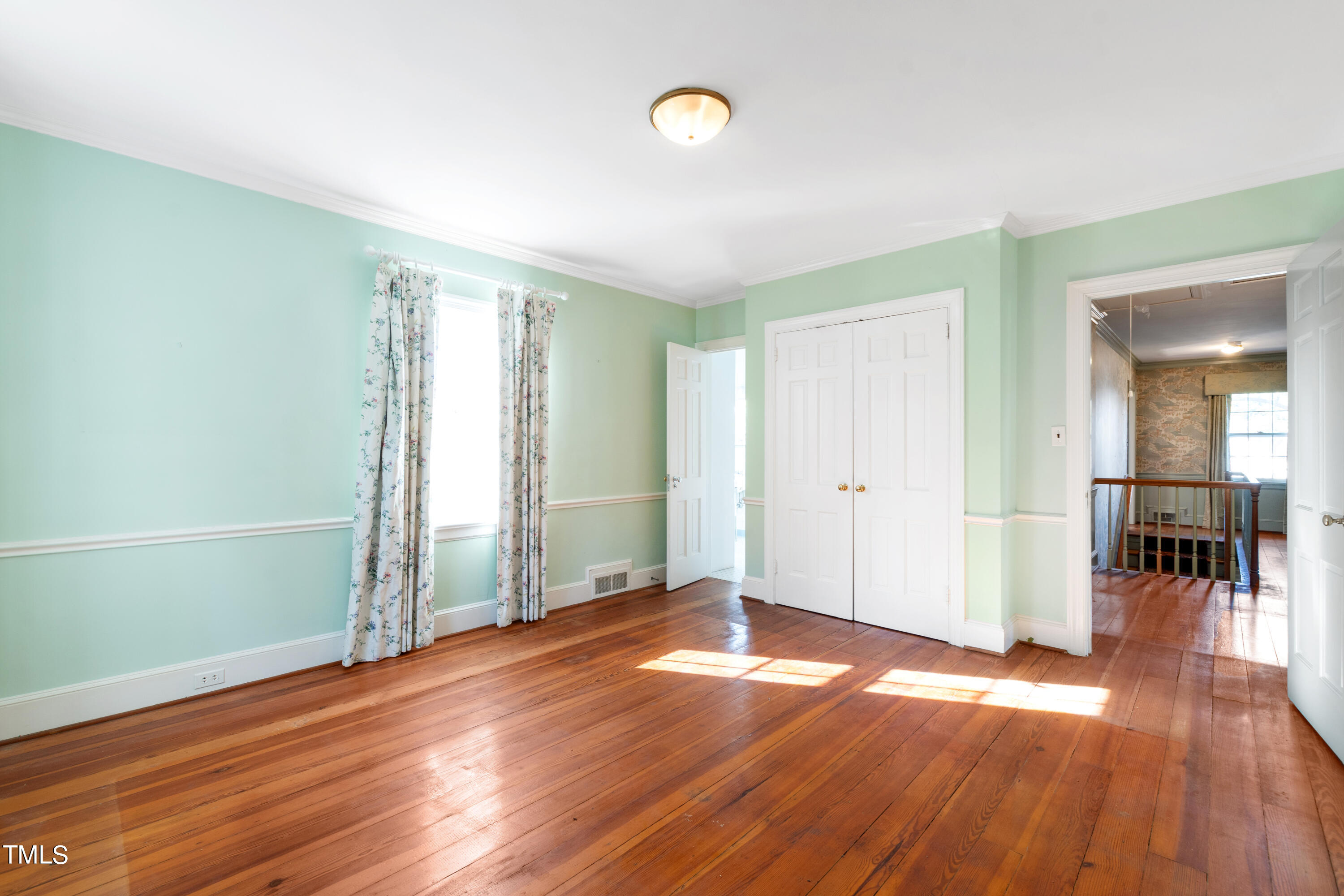 2522 Wake Drive Raleigh, NC 27608 - Photo 30 of 49 an empty room with wooden floor and windows