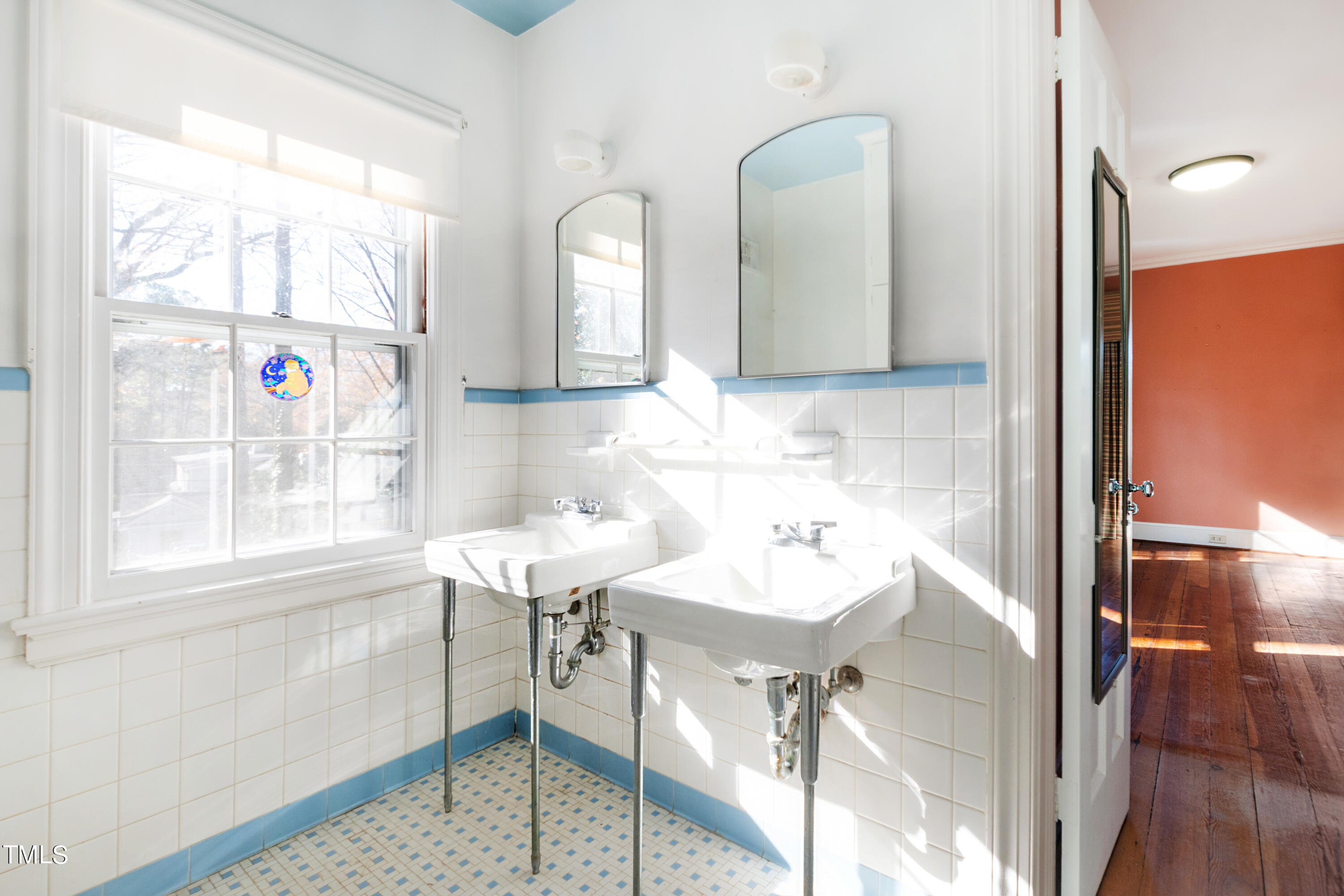 2522 Wake Drive Raleigh, NC 27608 - Photo 31 of 49 a bathroom with a sink a mirror and a shower