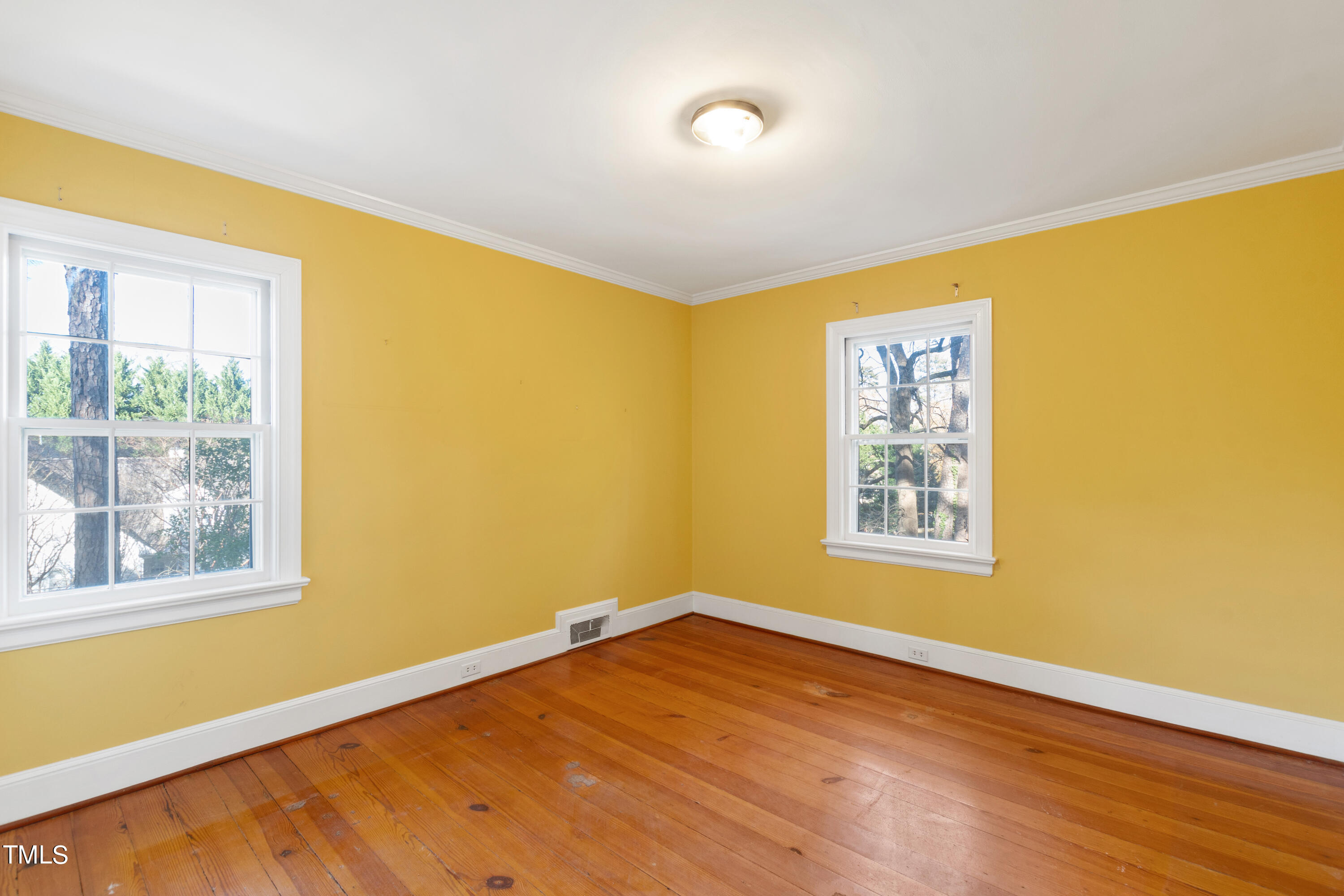 2522 Wake Drive Raleigh, NC 27608 - Photo 35 of 49 a view of an empty room with wooden floor and a window