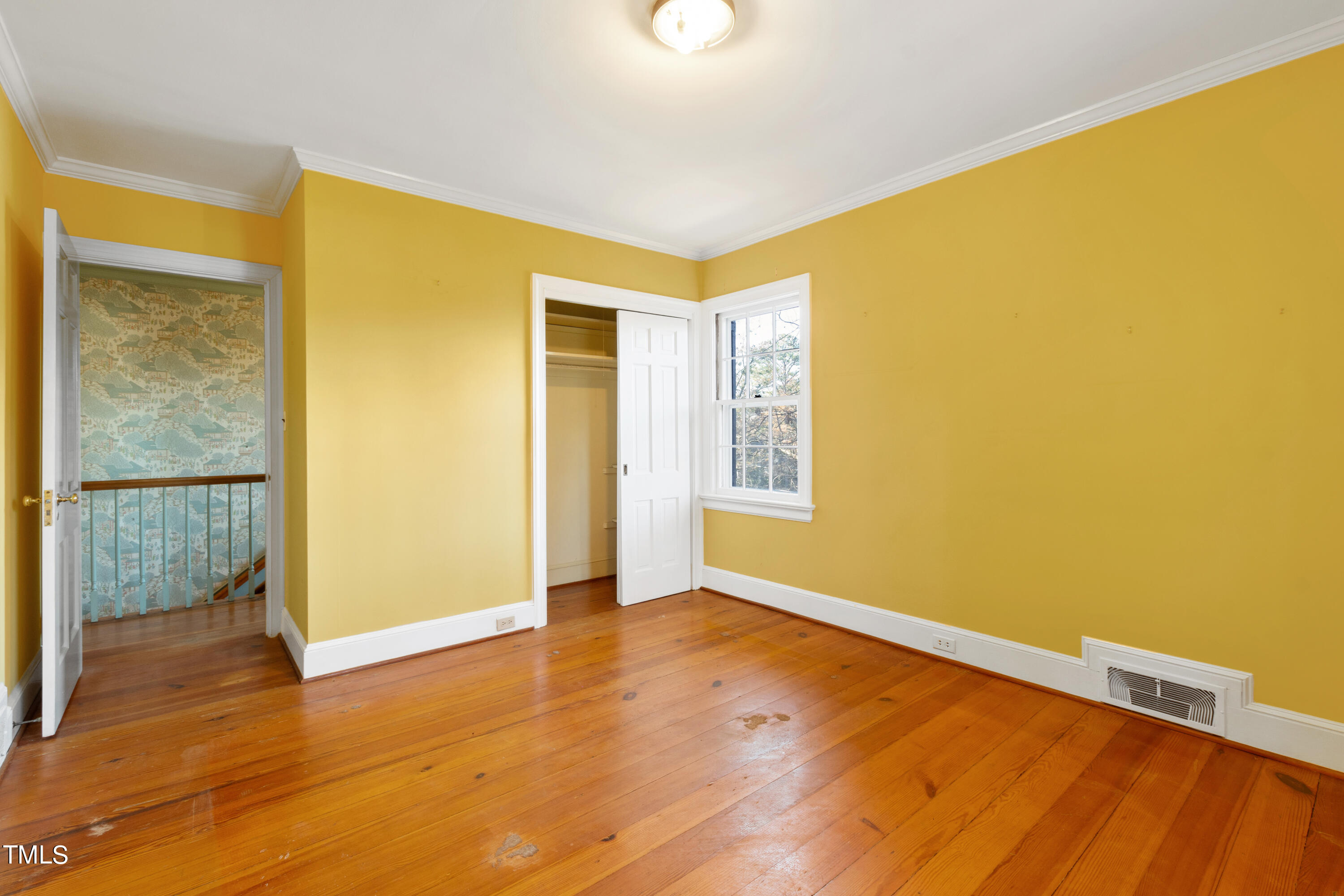 2522 Wake Drive Raleigh, NC 27608 - Photo 36 of 49 a view of an empty room with wooden floor and a window
