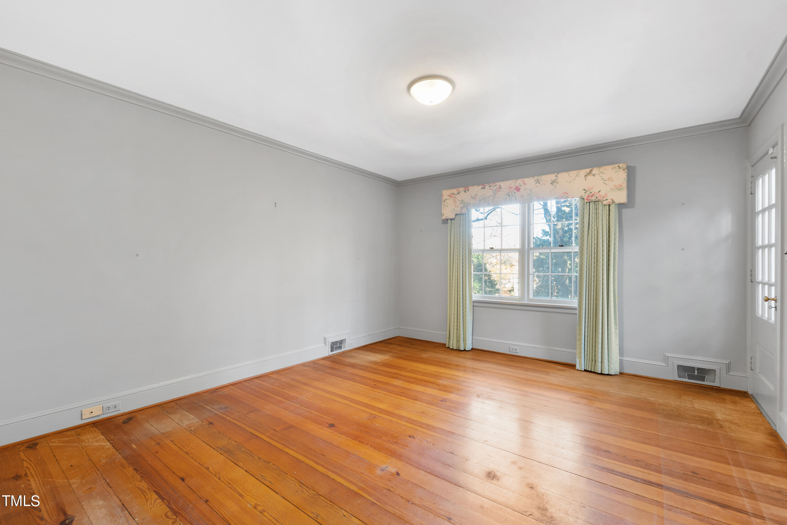 2522 Wake Drive Raleigh, NC 27608 - Photo 37 of 49 a view of empty room with wooden floor and fan