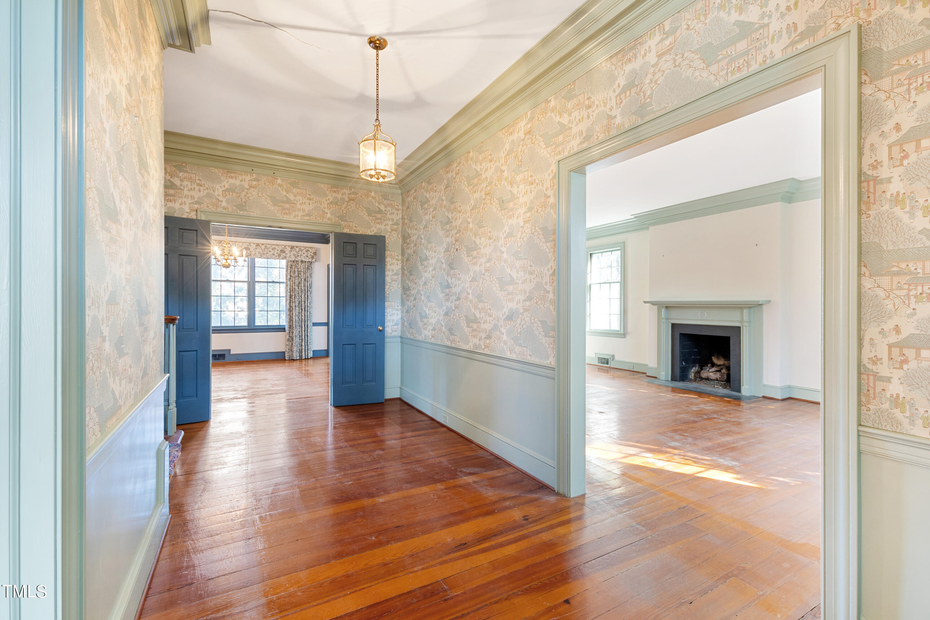 2522 Wake Drive Raleigh, NC 27608 - Photo 8 of 49 a view of a hallway with wooden floor and a fireplace