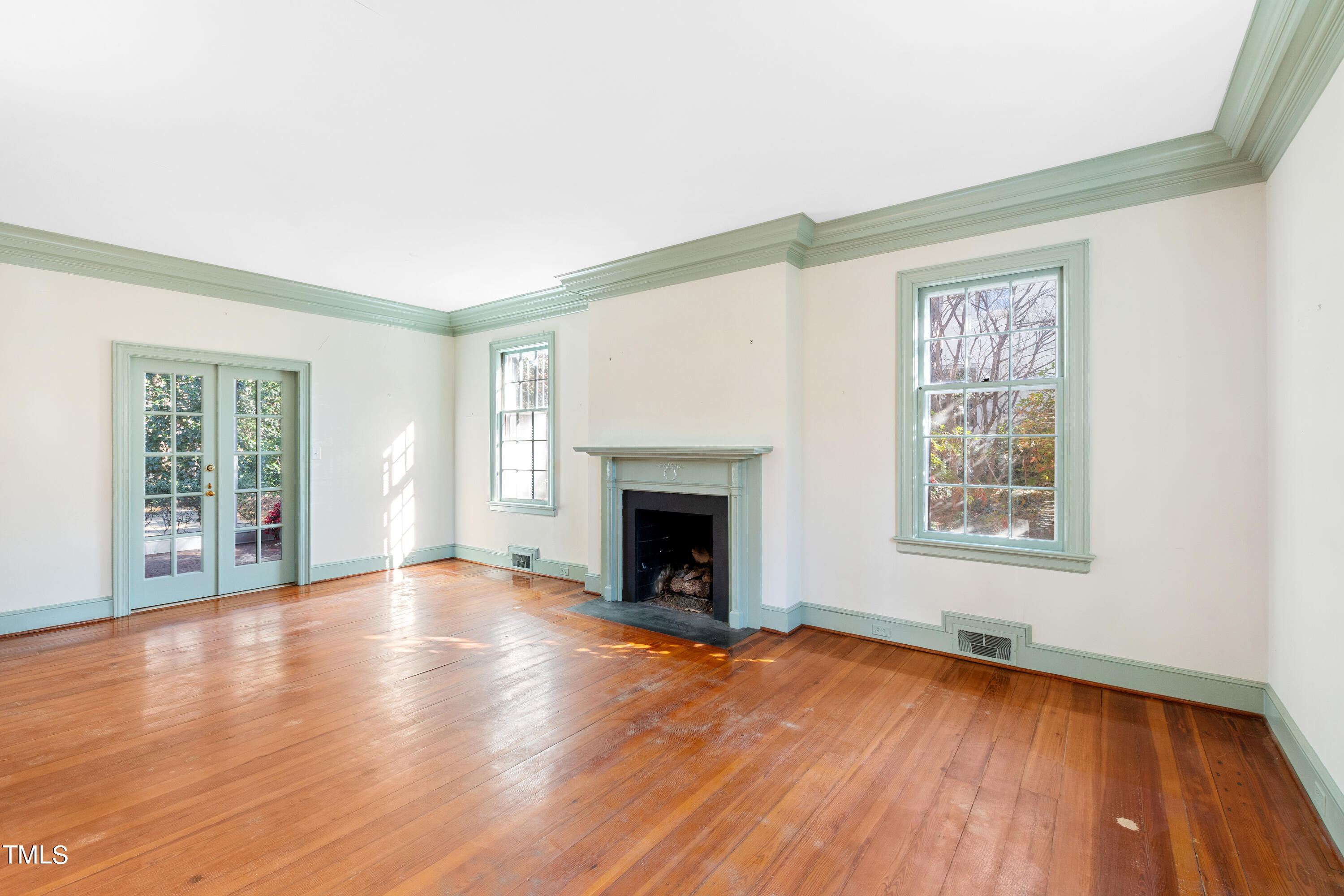 2522 Wake Drive Raleigh, NC 27608 - Photo 9 of 49 a view of an empty room with wooden floor and a window