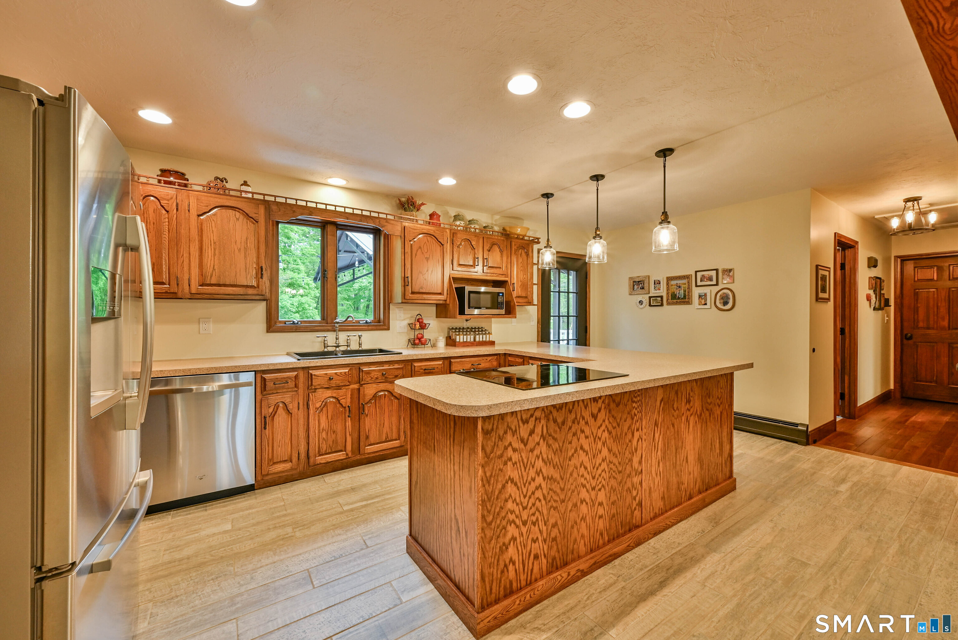 309 O'Leary Road Thompson, CT 06277 - Photo 24 of 40 a kitchen with stainless steel appliances granite countertop a sink a stove and a refrigerator