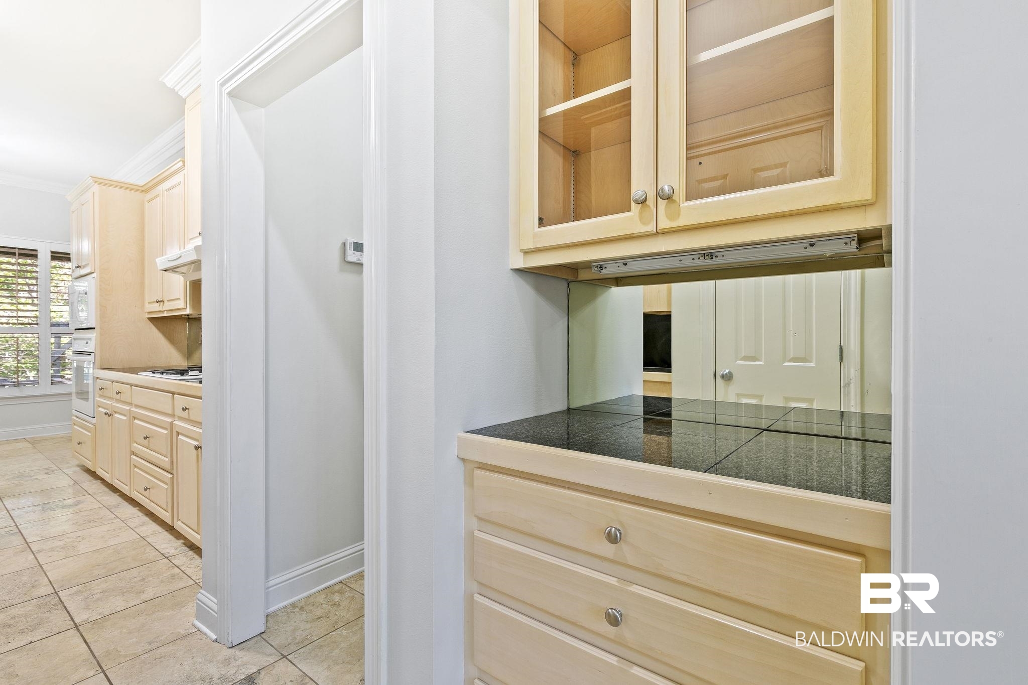 13 Bugle Retreat Daphne, AL 36527 - Photo 20 of 40 Kitchen featuring light brown cabinets, light tile patterned floors, white appliances, and ornamental molding