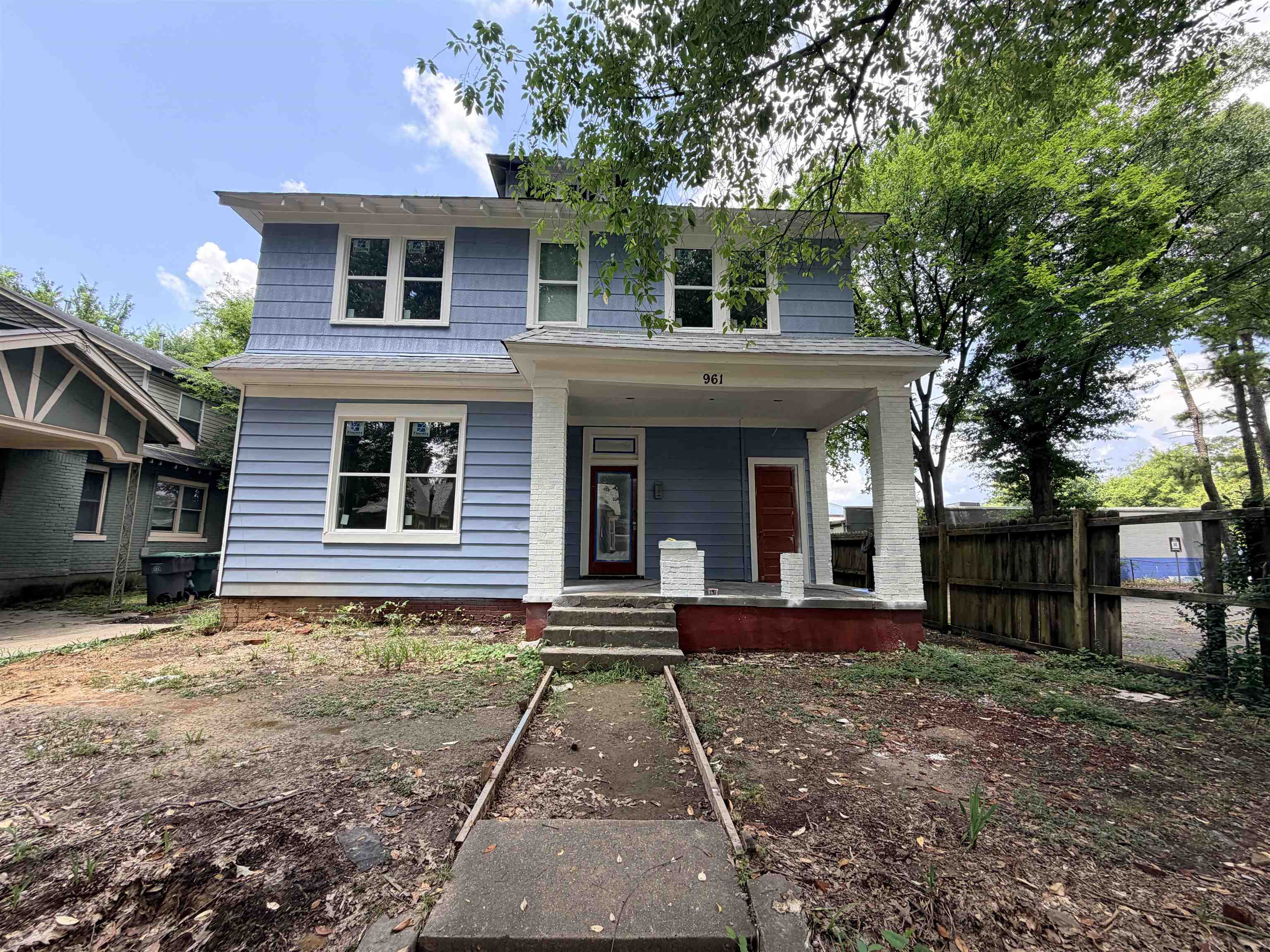 961 Meda Street Memphis, TN 38104 - Photo 2 of 27 Two-story facade featuring light blue horizontal siding and shingle accents
