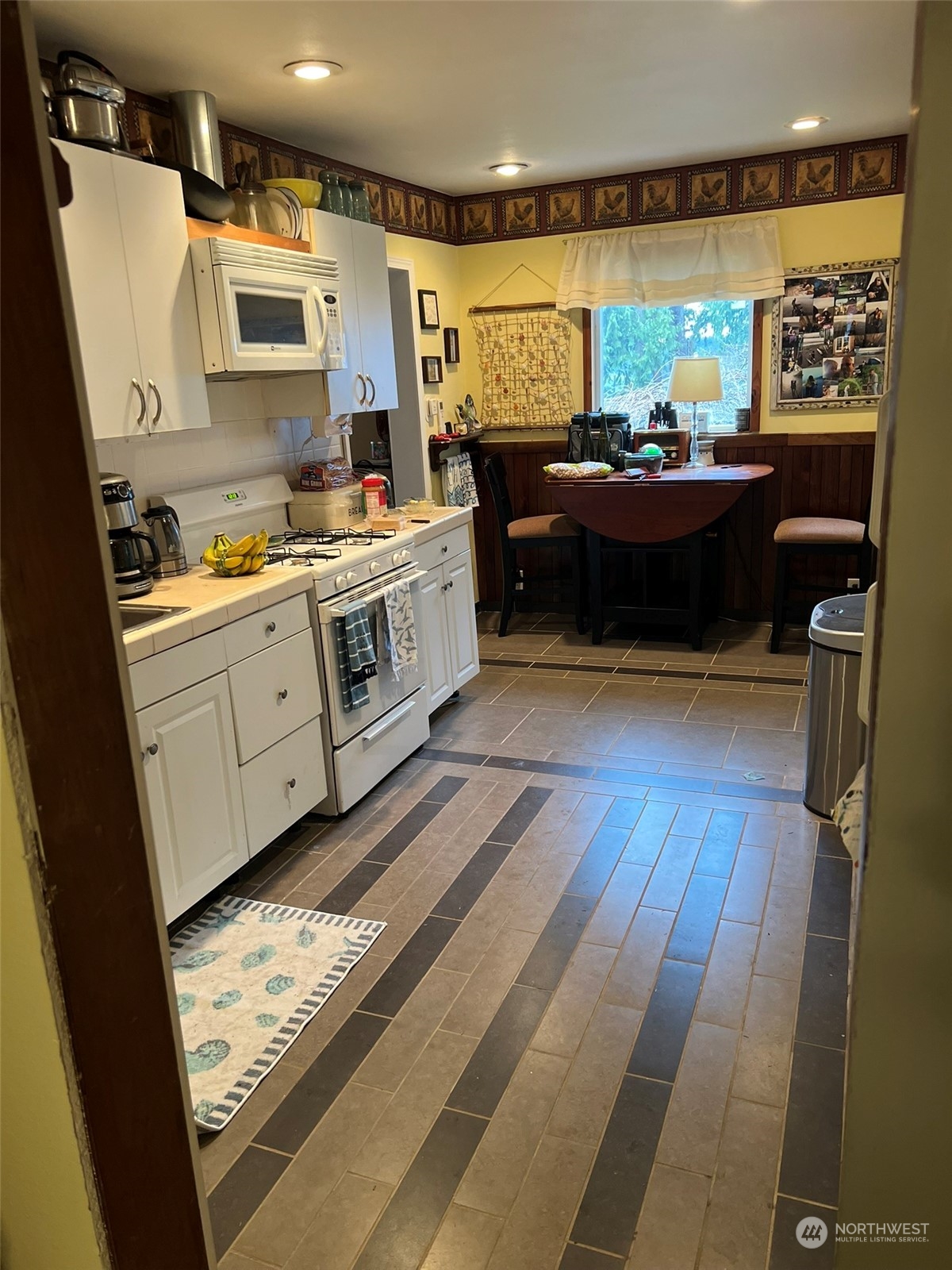 41 4th Street Pacific Beach, WA 98571 - Photo 14 of 23 a kitchen with stainless steel appliances granite countertop a stove a sink and a microwave