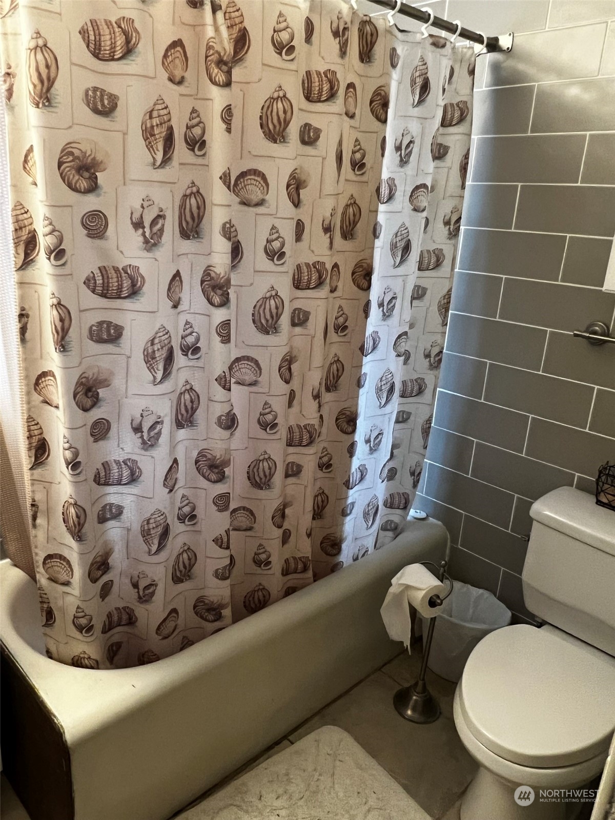 41 4th Street Pacific Beach, WA 98571 - Photo 22 of 23 a white toilet sitting next to a shower curtain