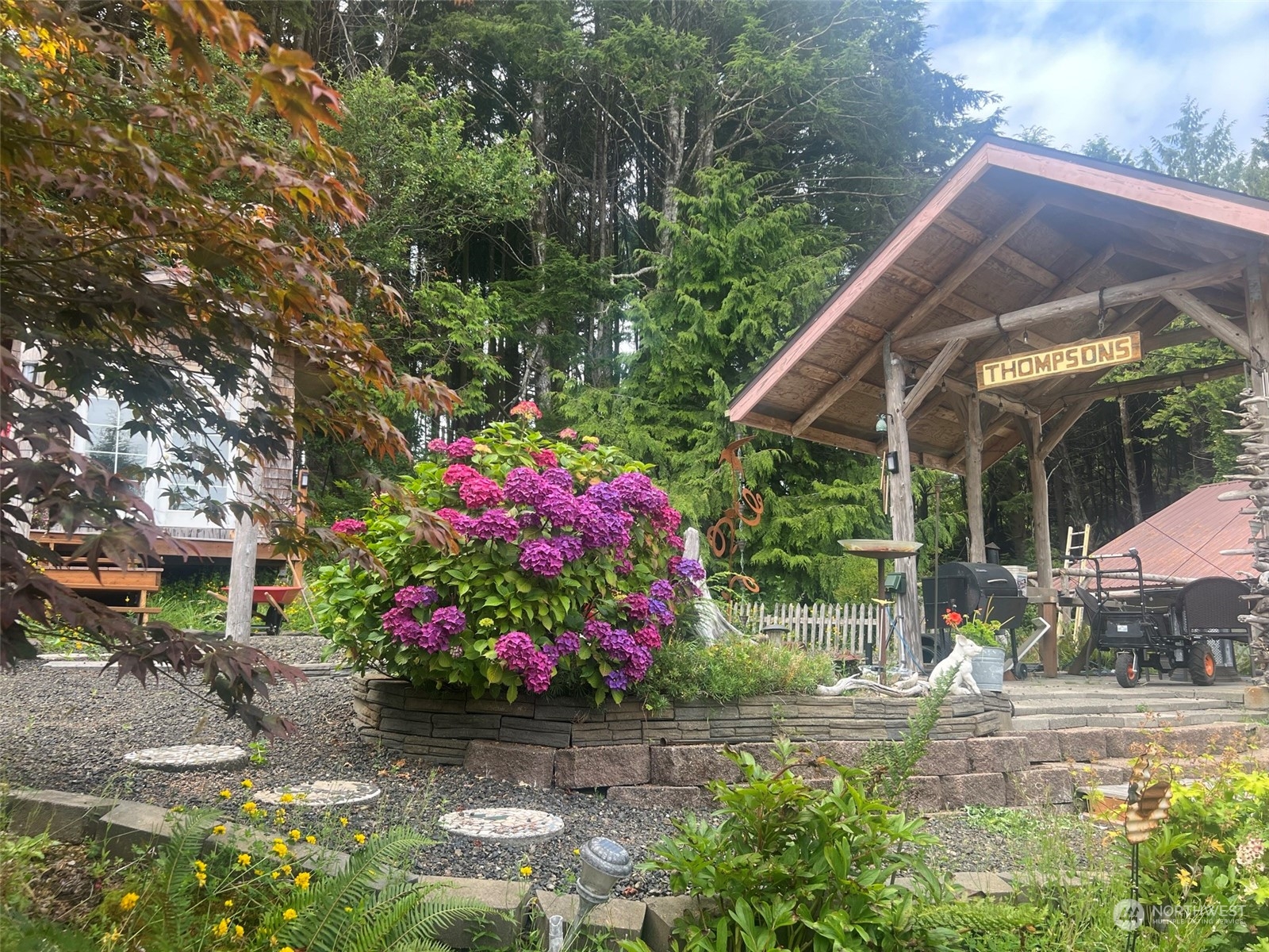 41 4th Street Pacific Beach, WA 98571 - Photo 6 of 23 a small garden covered with tall buildings
