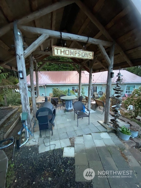 41 4th Street Pacific Beach, WA 98571 - Photo 7 of 23 a view of a chairs and table in patio with a barbeque