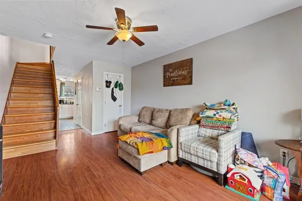 a living room with furniture and a wooden floor