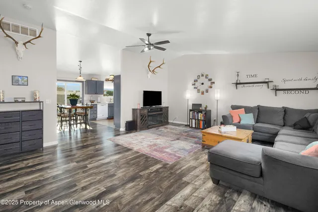 a living room with furniture and a wooden floor
