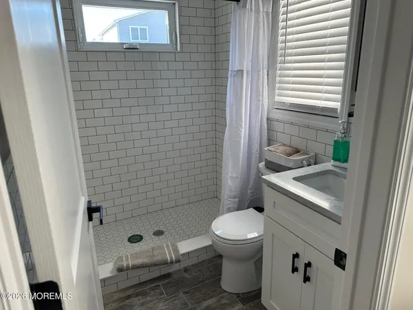 a white toilet sitting next to a bathroom sink