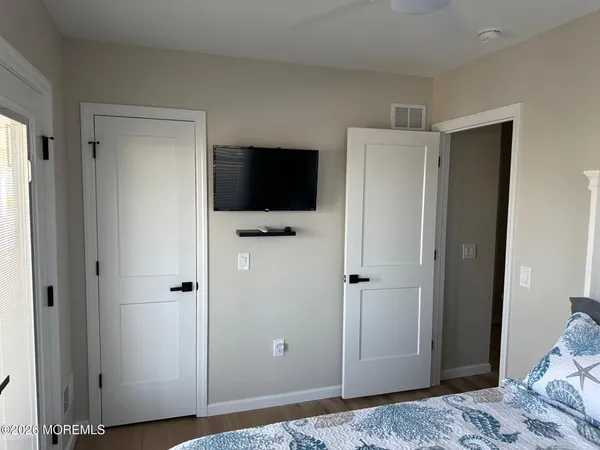 a view of bedroom with a bed and flat screen tv