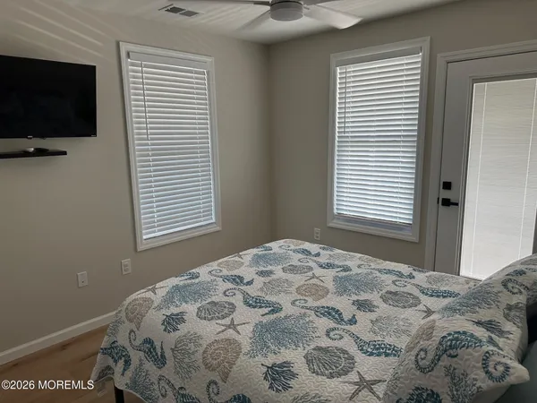 a bedroom with a bed and flat screen tv