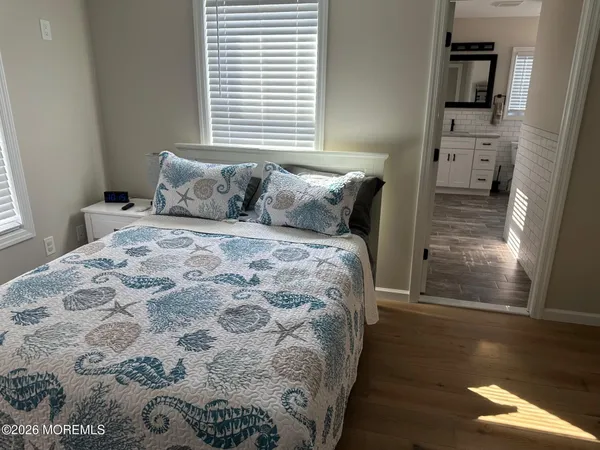a bed sitting in a bedroom next to a window