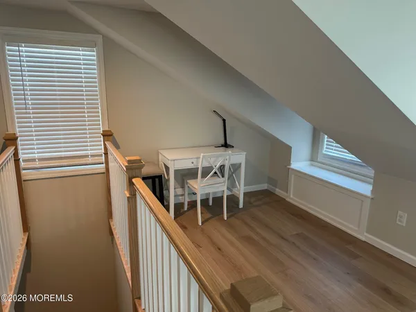 a view of entryway and hall with wooden floor