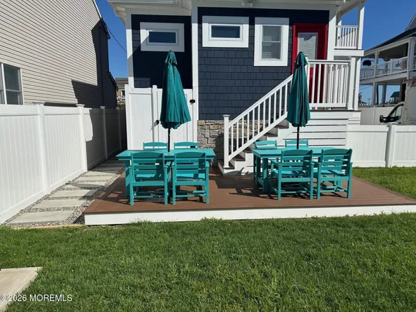 a view of a house with backyard porch and sitting area