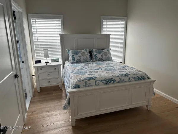 a bed sitting in a bedroom next to a window