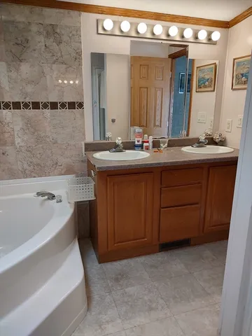 a white bath tub sitting next to a shower