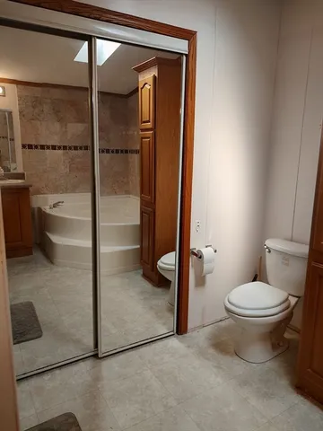 a bathroom with a toilet and a tub