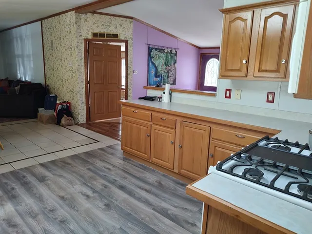 a kitchen with sink a stove and cabinets