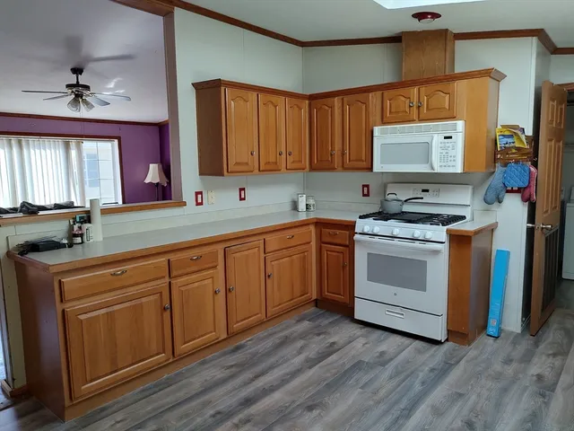 a kitchen with stainless steel appliances granite countertop a stove sink and cabinets