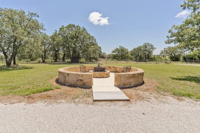 a view of a backyard with swimming pool