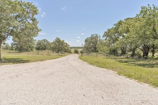 a view of a lake with a yard and trees
