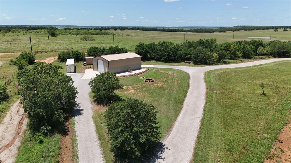 1216 Big Sandy Road Bellevue, TX 76228 - Photo 28 of 36 a view of a lake with a building in the background