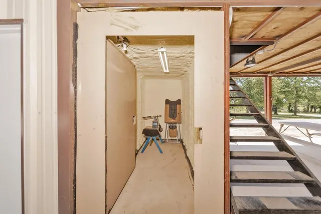 a view of a hallway with wooden floor and stairs
