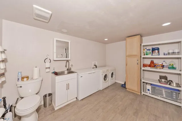 a spacious bathroom with a double vanity sink and a toilet
