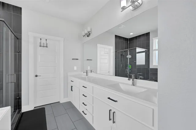 a bathroom with a double vanity sink and mirror