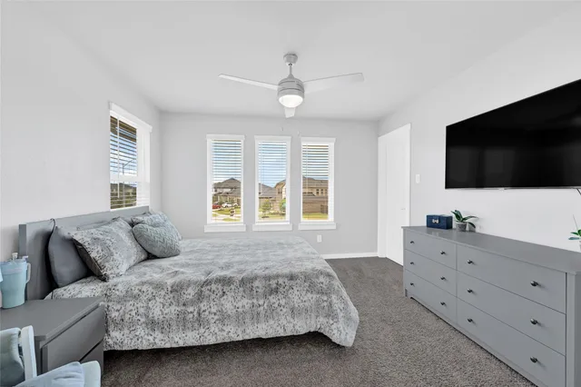 a bedroom with a large bed and a flat screen tv