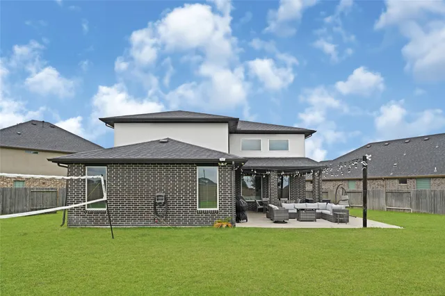 a view of a house with backyard porch and sitting area