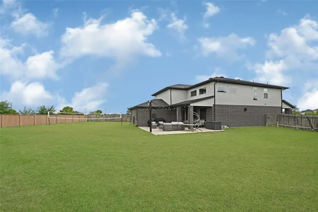 a view of a house with a big yard and a large tree