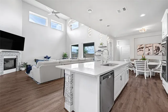 a large kitchen with cabinets table and chairs