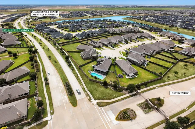 an aerial view of residential houses with outdoor space