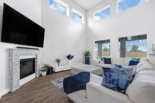 a living room with furniture a fireplace and a flat screen tv