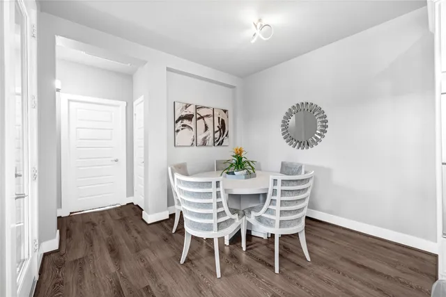 a view of a dining room with furniture and wooden floor