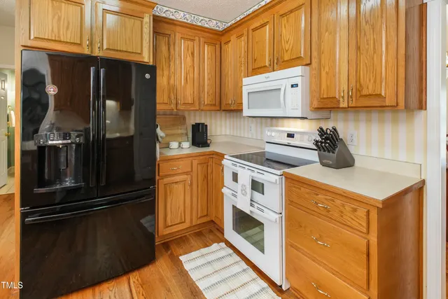 a kitchen with a refrigerator stove and sink
