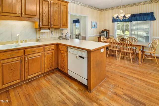 a kitchen with stainless steel appliances a sink and cabinets
