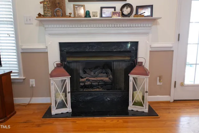a living room with a fireplace and a table