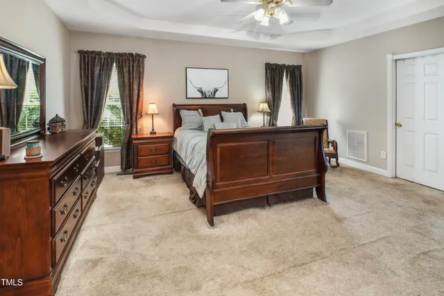 a bedroom with a bed and a chandelier